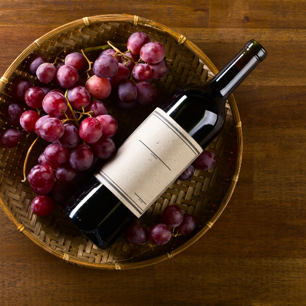 Grapes and wine bottle in a basket